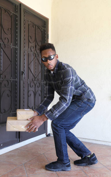 istock Porch Pirate African American Man Vertical 1333605655