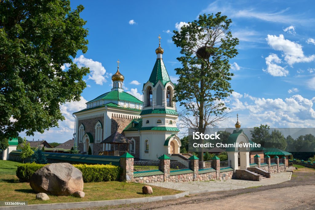 Old antique temple of Saints Unmercenaries and Wonderworkers Cosma and Damian in Vishnevo at summer, Minsk region, Belarus. Ancient Stock Photo