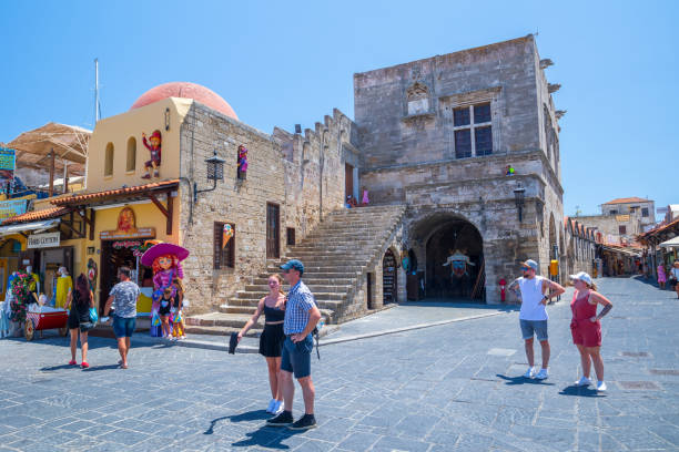 sightseeing place at hot summer sunshine afternoon. tourists at the intersection aristotle str""socrates str- hippocrates square at the rhodes old town of rhodes, greece - editorial built structure fountain town square imagens e fotografias de stock