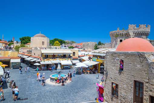 Rhodes, Greece - June 29, 2021: sightseeing place at hot summer sunshine afternoon. Tourists at the intersection Aristotle Str\
