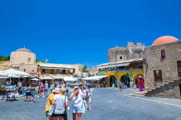 sightseeing place at hot summer sunshine afternoon. tourists at the intersection aristotle str""socrates str- hippocrates square at the rhodes old town of rhodes, greece - editorial built structure fountain town square imagens e fotografias de stock