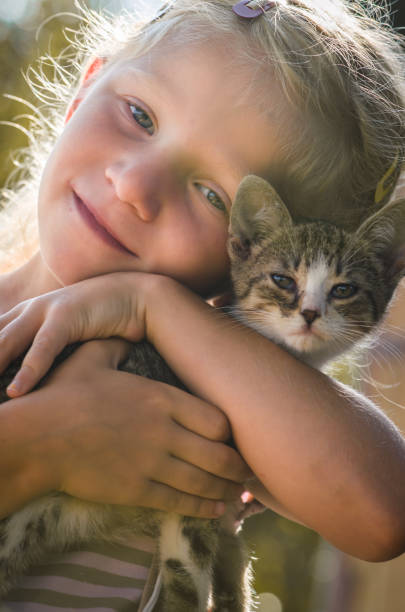 istock happy child and animal cat together 1333612080