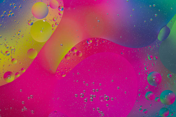 Close up image of mixed oil with water on colorful gradient background