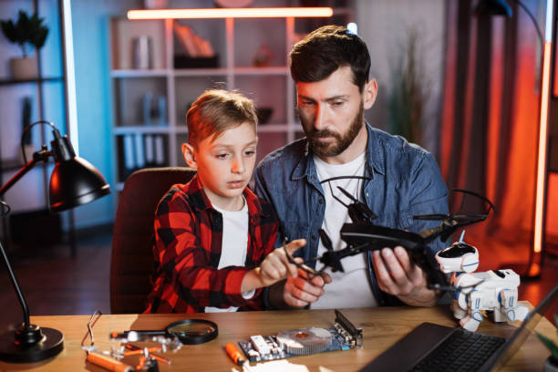 istock Father with son fixing modern quadcopter at home 1333613485