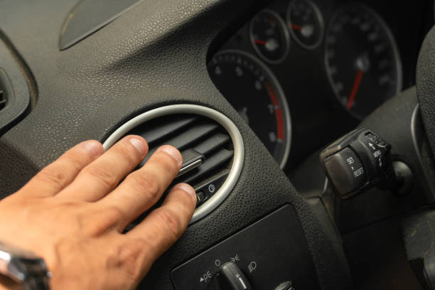 male hand close-up adjusts the air conditioner in the car, car interior - car air conditioner vehicle interior driving imagens e fotografias de stock