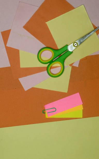 istock Color paper and scissors lying on table. DIY Paper Crafts cutting and making creative art background photography. Directly above. Flat lay. 1333616468