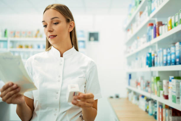 istock Young woman druggist at work, checking lists 1333619893