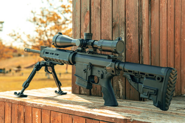 istock Automatic carbine with a telescopic sight. A sniper weapon mounted on a bipod. Gun for long-range aimed shooting. 1333621252