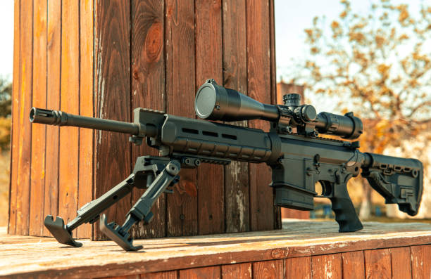 istock Automatic carbine with a telescopic sight. A sniper weapon mounted on a bipod. Gun for long-range aimed shooting. 1333621256