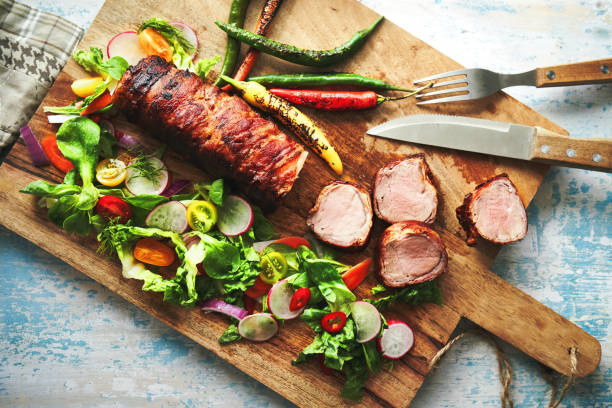 istock Pork Fillet with Bacon and Healthy Salad 1333621456