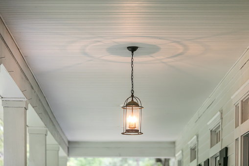 Hanging lantern on a front porch of a white house