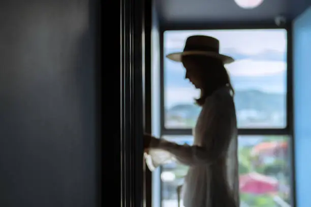 Photo of Woman tourist in casual clothes is walking to her room.