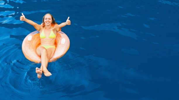 Little girl is jumping and playing in the ocean