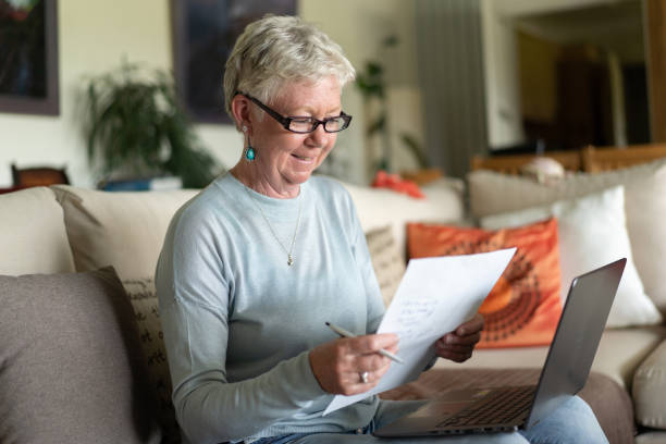istock Smiling lady studies her financial forecast 1333623535