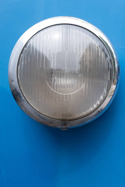 istock Closeup of a vintage train headlight with a chrome trim on blue surface 1333624585