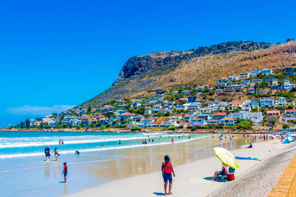 people and tourism in fish hoek beach at false bay in cape town western cape south africa. - south africa coastline sea wave imagens e fotografias de stock