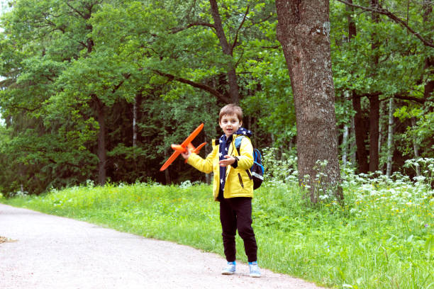 istock A boy launches a toy plane in a summer meadow 1333632855