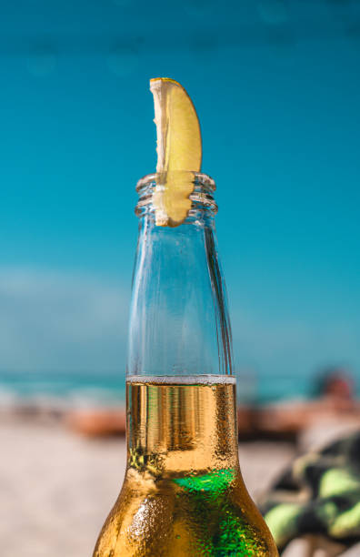 istock Beer bottle with lemon with beach on background - Isla Mujeres, Cancun. 1333633981