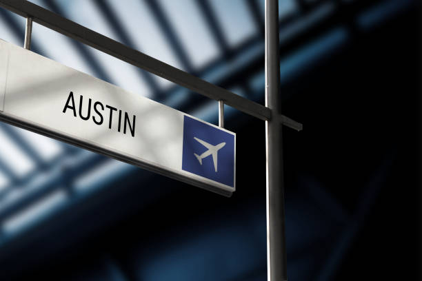 Airport departure for Austin information board sign Airport departure for Austin information board sign. Close-up. Roof construction in the background. Blue color. Horizontal orientation. austin airport stock pictures, royalty-free photos & images