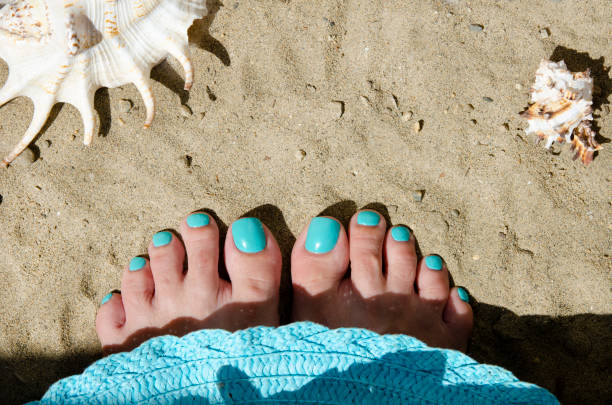Turquoise nail polish. Nice pedicure fingers. Health and body care. Place for your text.