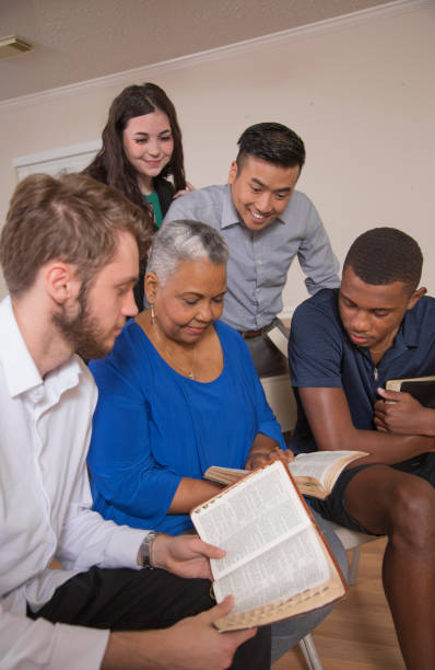 istock Bible Study.  Multi Ethnic Group.Multi Ethnic Group of friends meet for a Bible Study.  Group includes a teenager, young adults, mid-adult and senior adult. 1333641089