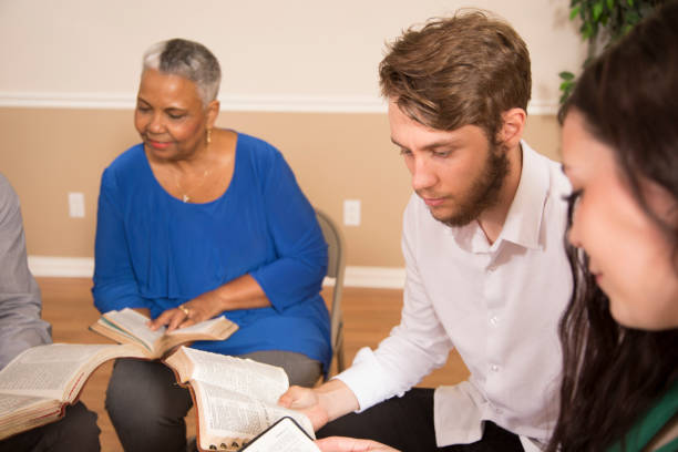 istock Bible Study.  Multi Ethnic Group.Multi Ethnic Group of friends meet for a Bible Study.  Group includes a teenager, young adults, mid-adult and senior adult. 1333641101