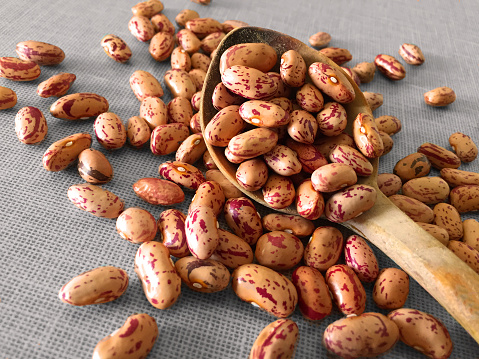 beans with wooden spoon on white background