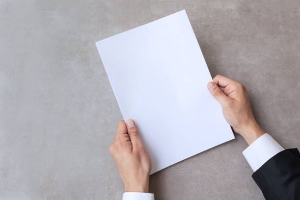 istock Male hands holding blank white paper 1333647216