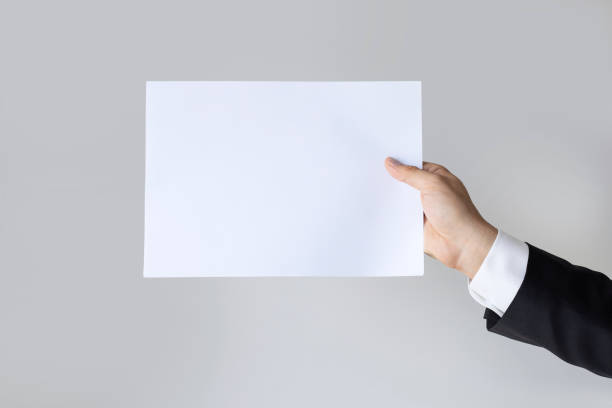 istock Male hands holding blank white paper 1333647221