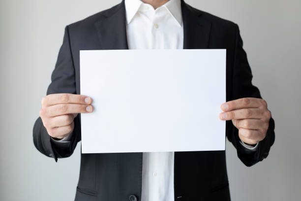 istock business man with blank paper 1333647349