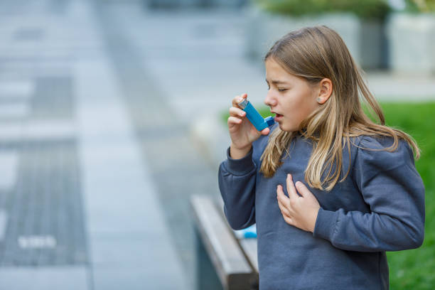 istock Cute Girl has Problems With Respiratory System so She Uses an Inhaler. 1333649966