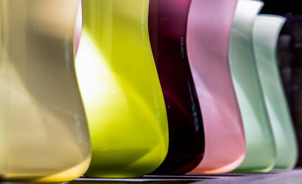 istock Vases for flowers are glass colored standing in a row with a perspective. 1333654703