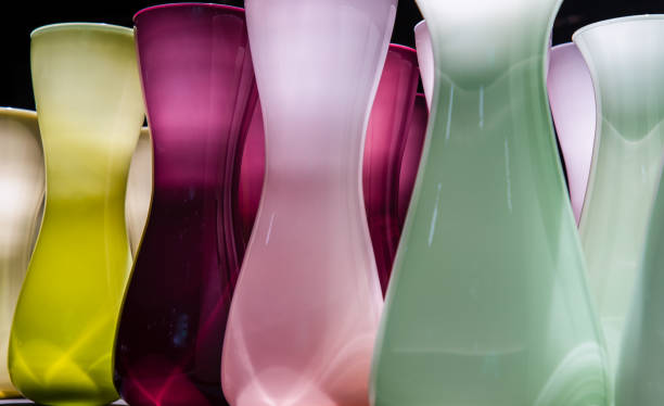 istock Vases for flowers are glass colored standing in a row with a perspective. 1333654705
