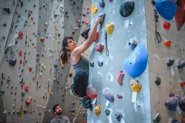 istock Belayer Watching Female Sport Climber Ascending Pillar 1333654978