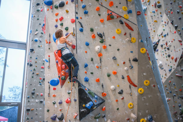 istock Strong Young Woman Ascending Pillar Climbing Wall 1333655001