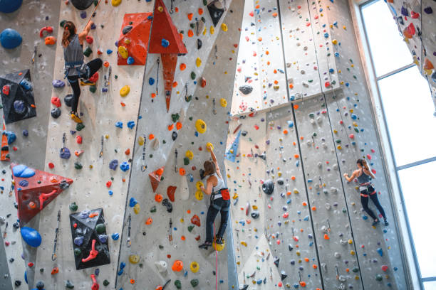 istock Three Sportswomen Practicing on Climbing Walls in Gym 1333655018