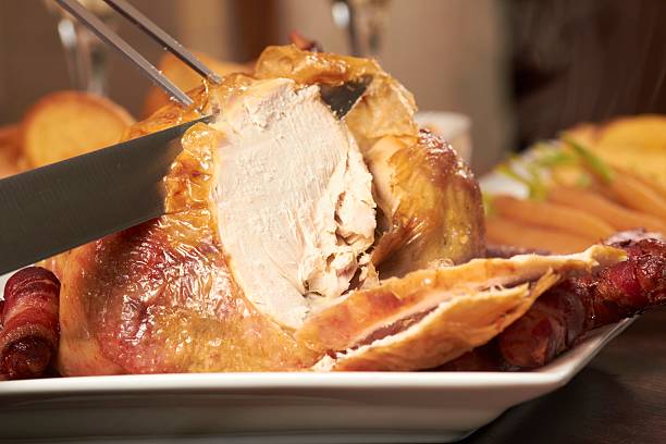 A chicken being carved