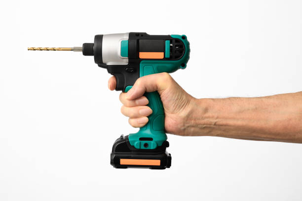 istock Isolated shot of hand holding a cordless drill with drill bit on white background 1333671034
