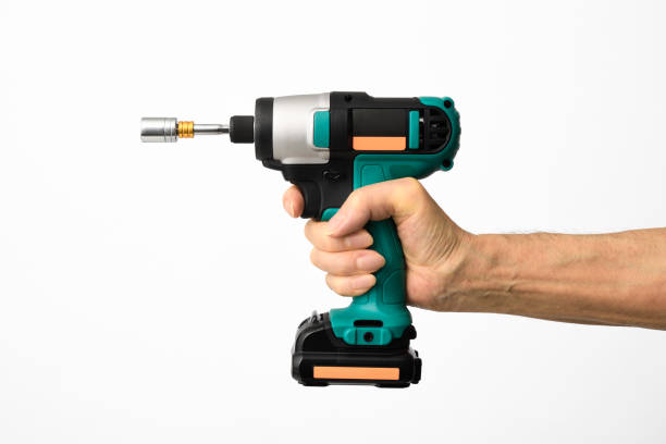 istock Isolated shot of hand holding a cordless drill with socket wrench on white background 1333671048
