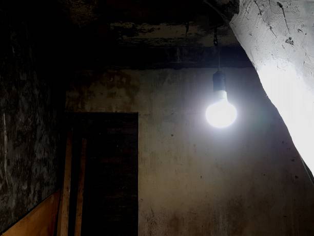 istock incandescent light in a dark, shabby and musty room.  peaceful solitude 1333671078