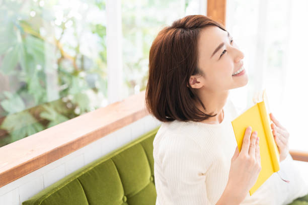 istock attractive asian woman who reads a book, 1333673567
