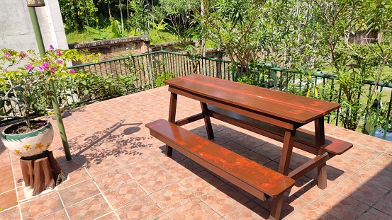 Set of Wooden Bench And Table Under The Hot Sun at Afternoon