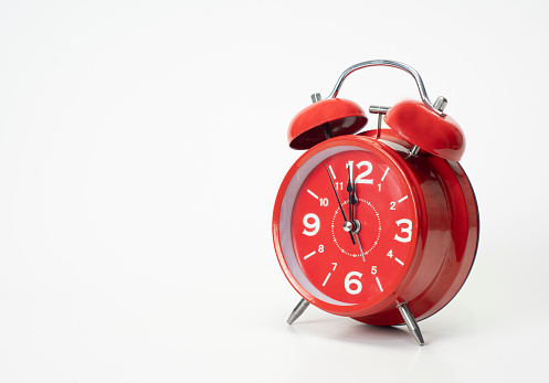 Red alarm clock cut out a white background, Copy space