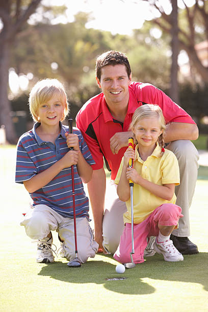 istock Father Teaching Children To Play Golf 133368302