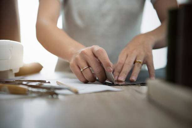 istock Close up hand of woman while draft patterns on fabric with tailor`s chalk for sewing. 1333685937