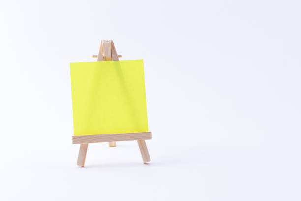 istock Wooden Easel Miniature with Blank Colored Square Canvas or Memo Paper 1333686678