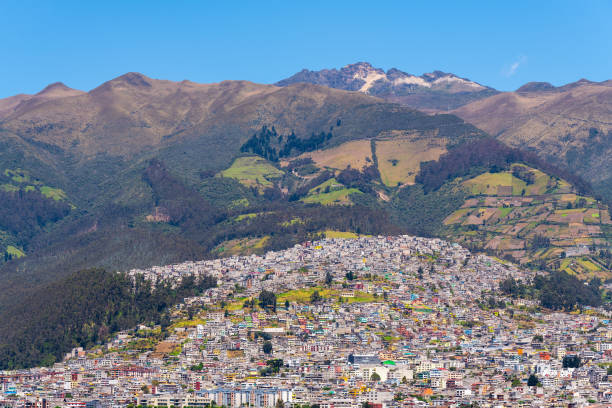 Quito city built on the active Pichincha volcano slopes and view over the highest peak, the Rucu Pichincha, Quito, Ecuador.