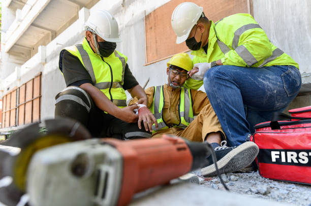 istock First aid team support to builder worker after hand injury bleeding, accident in work, Using construction power tools unsafe and negligence at construction site. Safety in work concept. 1333691151