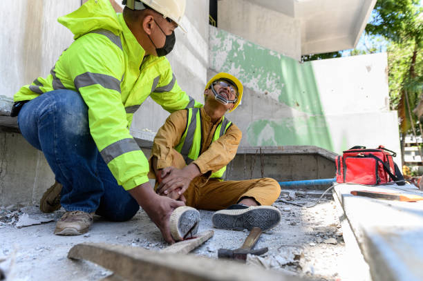 istock Builder worker has an accident at work. His feet stepped on nails embedded in wood old with foreman rushed in to take care. First aid and Safety in work concept. 1333691171
