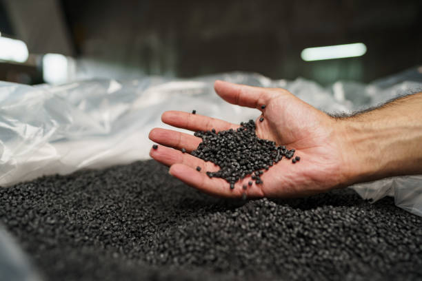 istock Close up of male hand holding plastic polymer granules 1333692008